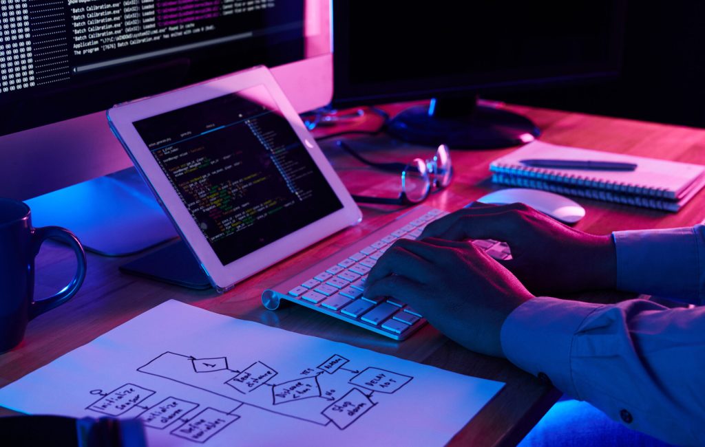 Close-up image of programmer working at his desk in office